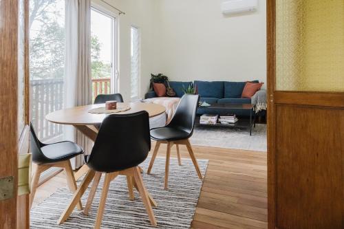 a living room with a table and chairs at Port Kembla Laneway Cottage in Port Kembla
