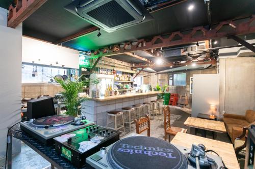 a restaurant with a counter and a bar at momodani agito 桃谷アジト in Osaka