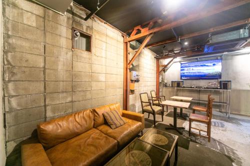 a living room with a couch and a table at momodani agito 桃谷アジト in Osaka