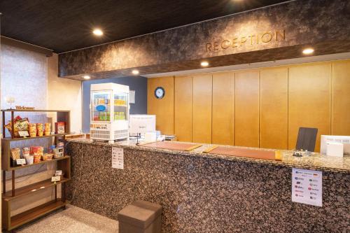 a reception area of a restaurant with a counter at Omura Central Hotel in Omura