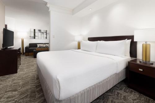 a large white bed in a hotel room at SpringHill Suites Fresno in Fresno