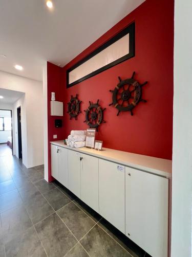 a room with a red wall with a counter and a window at Roxy Sematan Beach Townhouse Deluxe 7 ,8 ,9, 10 ,11 ,12 in Sematan