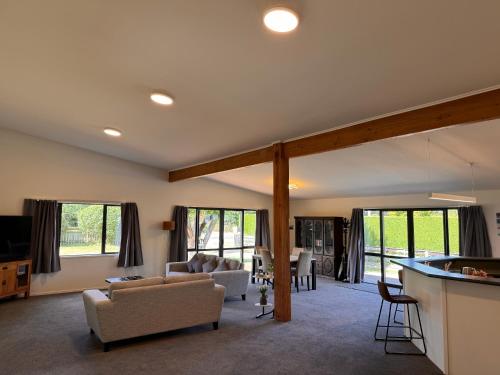 a living room with a couch and a table at Woodbank Retreat in Hanmer Springs