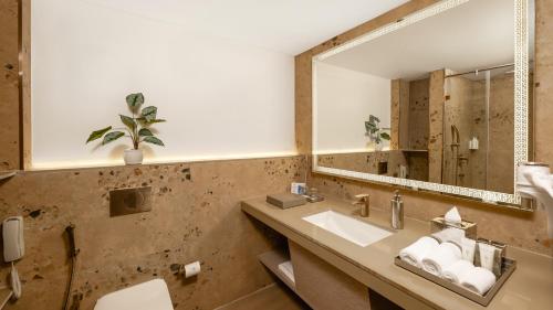 a bathroom with a sink and a mirror at Gateway Goa, Palolem in Palolem