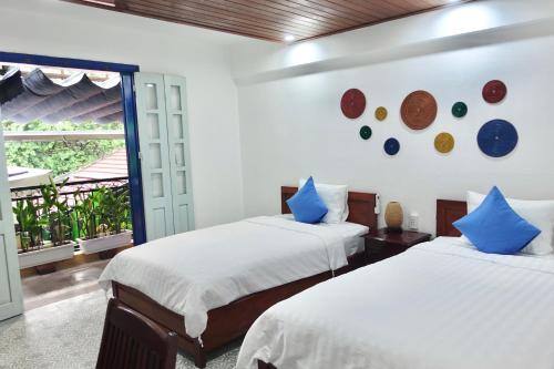 Postel nebo postele na pokoji v ubytování Hoi An Old Town Residence - 56 Phan Boi Chau, Hoi An