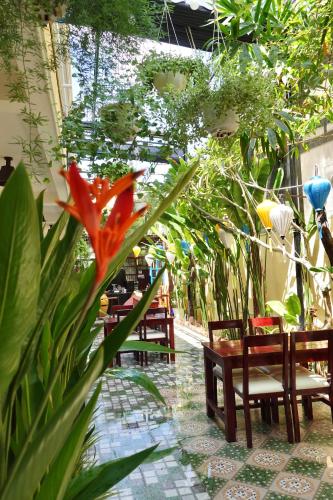 a patio with benches and a flower and plants at Hoi An Old Town Residence - 56 Phan Boi Chau, Hoi An in Hoi An