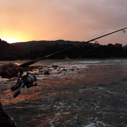a person holding a camera while fishing on a river at Ikaya Accommodation PSJ in Port St Johns