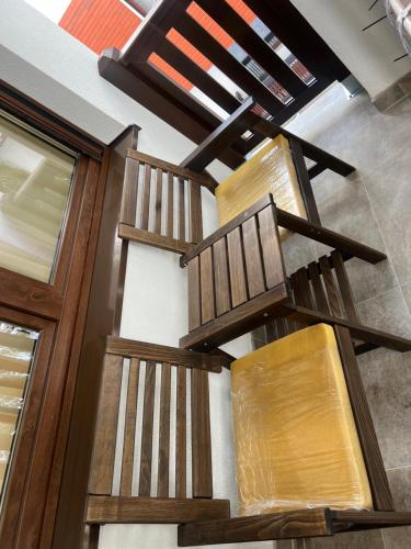 a set of three wooden staircases in a building at Ruža vetrova A1- duplex in Nova Varoš
