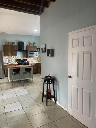 a kitchen with a table and a white door at Casa Relax in West End