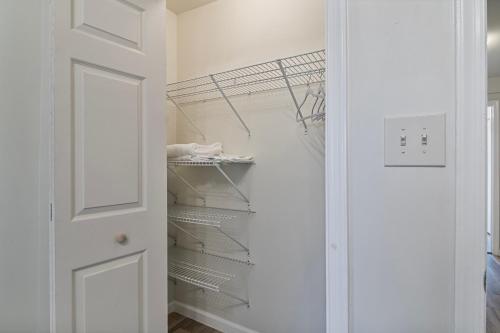 a closet with white walls and a white door at USNA Home In Downtown Annapolis in Annapolis