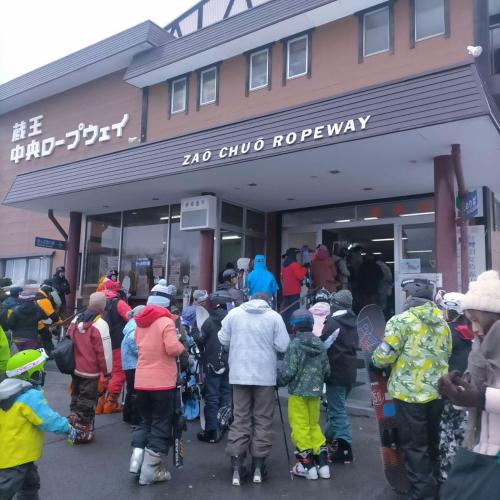 a group of people standing outside of a ski shop at 一棟貸し 露天風呂付き Snowfall Meteor in Kaminoyama