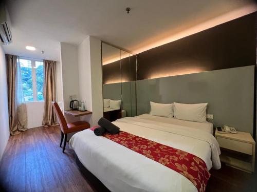 Postel nebo postele na pokoji v ubytování Sakura Elite Kuala Lumpur