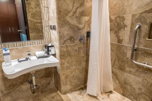 a bathroom with a sink and a shower at Sheraton Guayaquil in Guayaquil