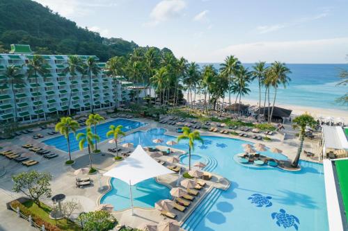 an aerial view of a resort with a pool and the ocean at Le Meridien Phuket Beach Resort in Karon Beach