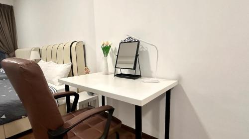 a white table with a mirror and a chair at LM HomeyC 3BR Family Suite for 4-14 Pax with Nexflix & Coway Water Purifier in Tanjong Tokong