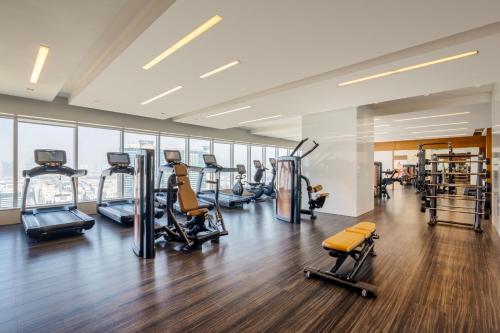 a gym with treadmills and cardio equipment in a building at Marriott Hotel Downtown Abu Dhabi in Abu Dhabi
