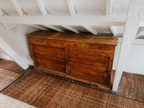 a wooden cabinet in the corner of a room at The Lookout Cabin in Pupuan Tabanan Bali in Tabanan