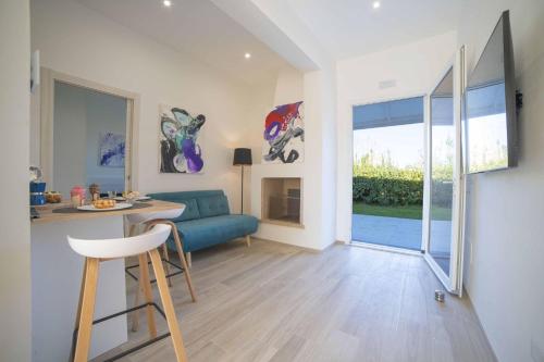 a living room with a blue couch and a table at Villa Assunta With Pool Near The Sea - Happy Rentals in Melendugno