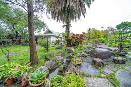 a garden with rocks and plants in a yard at Hua Qing Yuan in Yuanshan