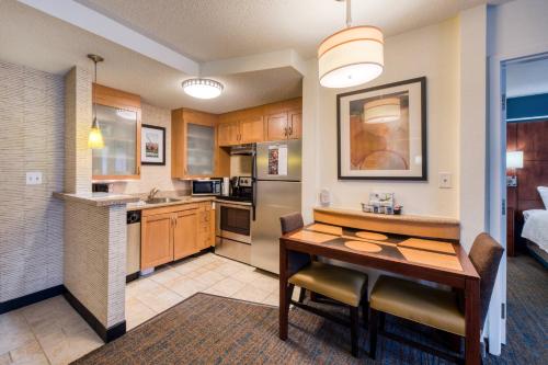 a kitchen with a table and a dining room at Residence Inn by Marriott Chapel Hill in Chapel Hill