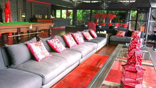 a living room with couches and a pool table at 05 - Exquisite Paradise Retreat in Nai Thon Beach