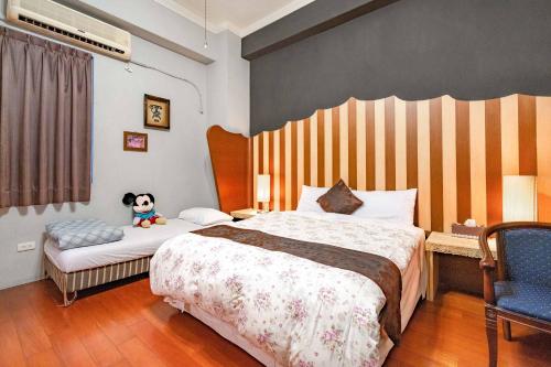 a bedroom with a bed with a stuffed dog sitting on it at Hua Qing Yuan in Yuanshan
