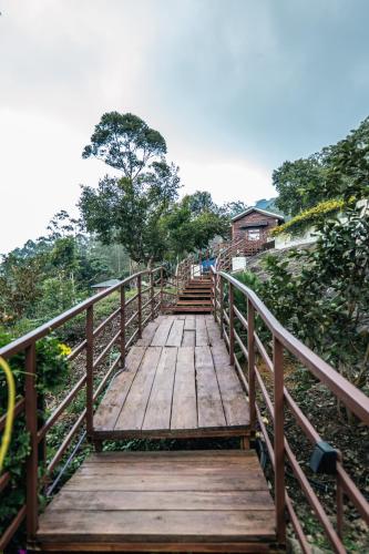a wooden bridge leading up to a building at Hilltop Munnar by Fracspace in Munnar