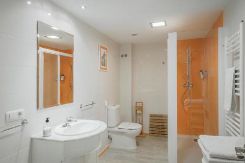 a white bathroom with a sink and a toilet at El Cedro in Abejar
