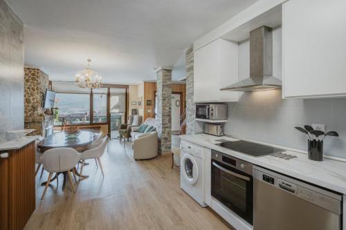 a kitchen with a table and a dining room at El Cedro in Abejar