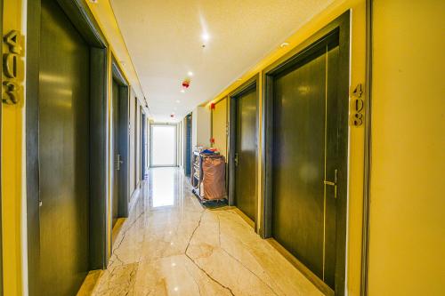 an empty hallway with green walls and floors and a hallway with at Fabhotel Prime Elite Janakpuri in New Delhi