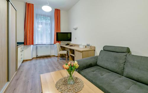 a living room with a couch and a table at Hotel U Kozicky in Teplice