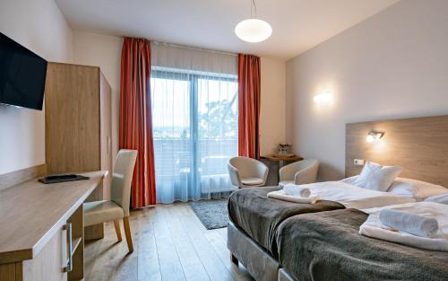 Postel nebo postele na pokoji v ubytování Hotel U Kozicky