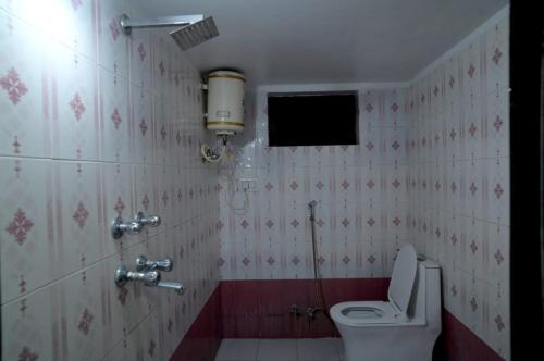a bathroom with a toilet and a sink at Mango Farm Resort in Udaipur