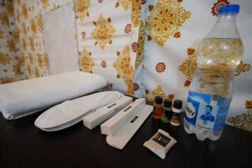 a table with a bottle of water next to a bed at Mango Farm Resort in Udaipur