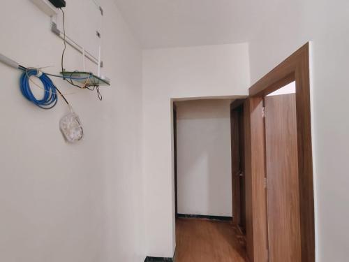 an empty room with a door and a room with at Malhar Guest House in Pune