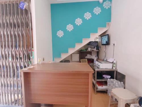 a room with a staircase with a desk and a stair case at Malhar Guest House in Pune