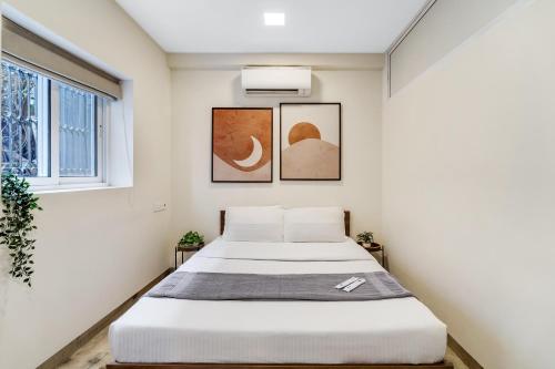 a bedroom with two beds and a window at Maven 1BHK Khar W by The Bombay Home Company in Mumbai