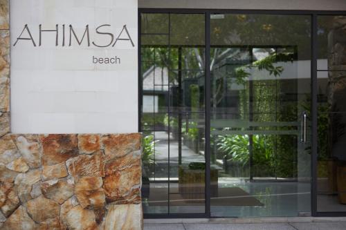 a sign on the side of a building at Ahimsa Beach in Jimbaran