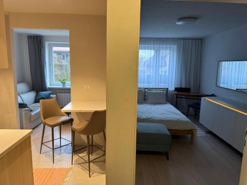 a bedroom with a bed and a living room at es studio in Staszów