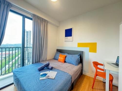 a bedroom with a bed and a desk with a laptop at X - The Papermill - Sunway Subang Jaya USJ1 SEGi Monash INTI Taylor Sunway Lagoon in Subang Jaya