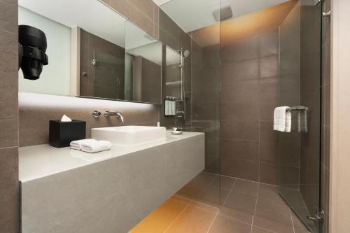 a bathroom with a sink and a shower at Hyatt Place Bangkok Sukhumvit 1 in Bangkok