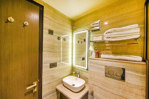 a bathroom with a sink and a mirror at Fabhotel Prime Elite Janakpuri in New Delhi