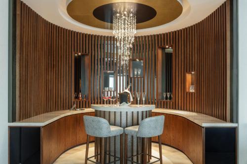 a lobby with two chairs and a chandelier at Marriott Marquis Dubai Creek in Dubai