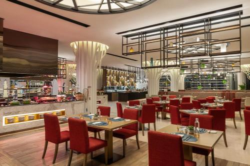 a restaurant with tables and chairs and a bar at Marriott Marquis Dubai Creek in Dubai