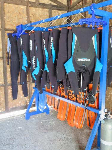a rack of tools hanging in a garage at The Wild Orchid Resort - Moalboal in Moalboal
