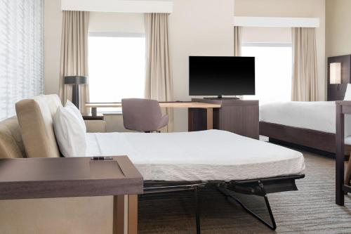 a hotel room with a bed and a tv at Residence Inn by Marriott Oklahoma City Norman in Norman
