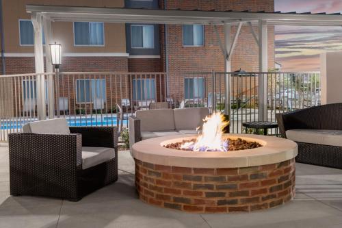 a fire pit in a patio with two chairs at Residence Inn by Marriott Oklahoma City Norman in Norman