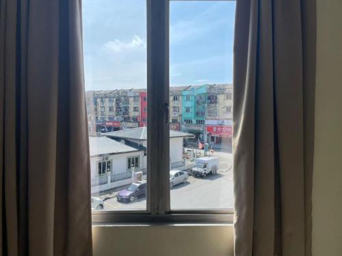 a window with a view of a parking lot at SV Andalas Hotel in Klang