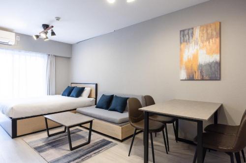a bedroom with a bed and a table and chairs at PREAS Nakano Arai in Tokyo