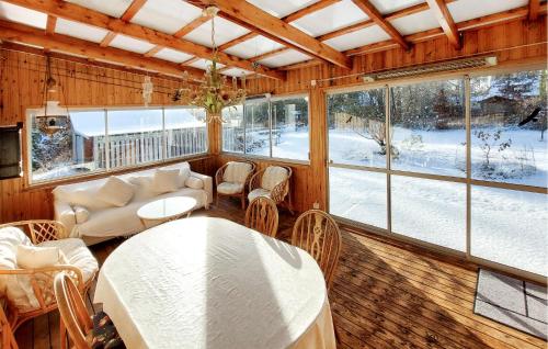 a living room with a table and chairs at Cozy Home In Vittsjö With Wifi in Vittsjö
